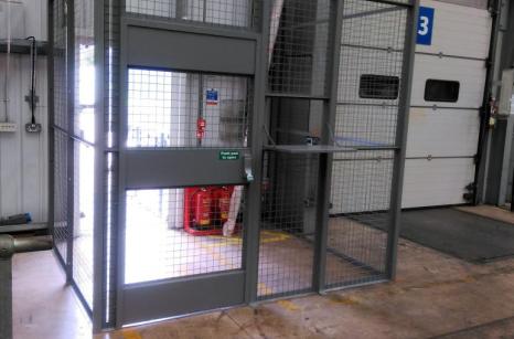 Restricted access to warehouse with drivers cage showing hatch open